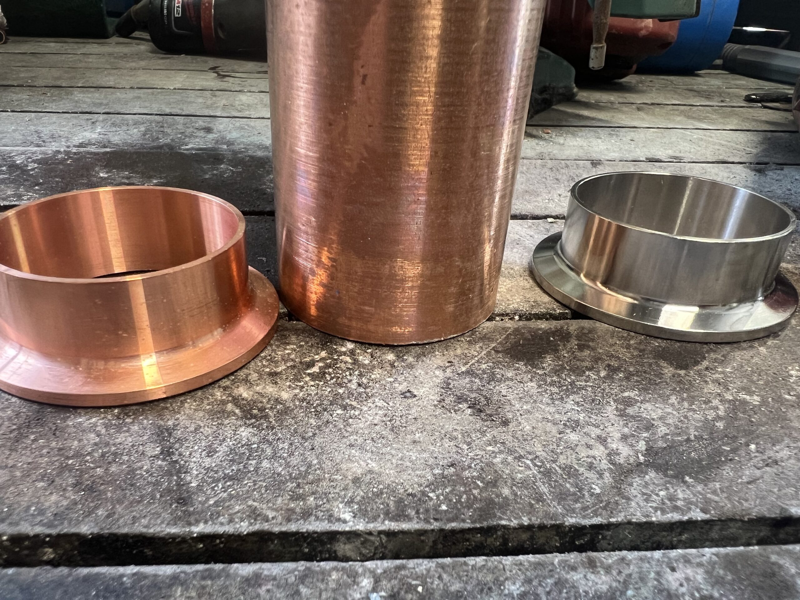 Copper pipe with stainless, and copper ferrule next to it.