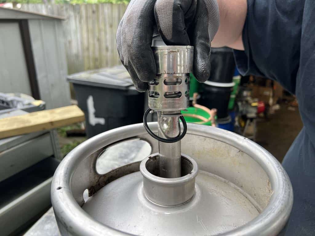 Removing the spear completely from the keg.
