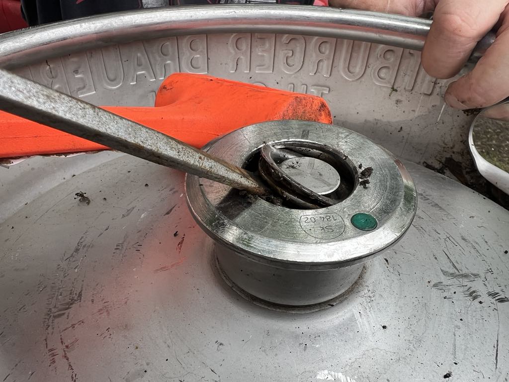 Prying on the retaining ring in a keg.