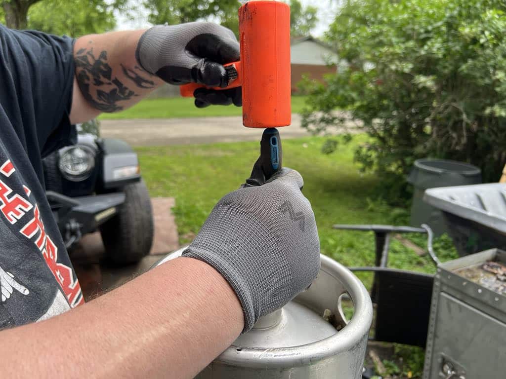 Releasing the pressure from a keg.