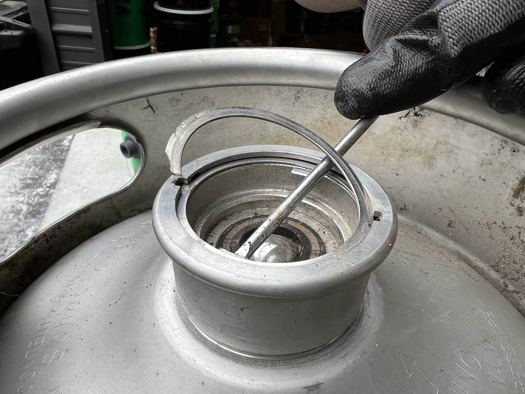 Removing the ring so the spear will come out of the keg.