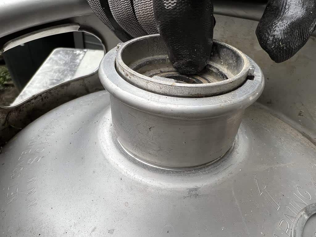 Lining up the tabs to remove the keg spear.