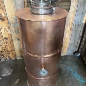30-gallon copper barrel still boiler replacing a standard 15-gallon stainless steel keg for double distilling capacity.