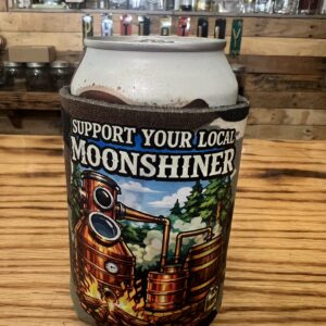Support Your Local Moonshiner camouflage can koozie featuring a graphic design of a traditional copper still running over a fire.