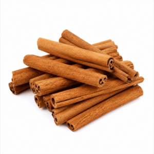 Whole cassia bark cinnamon sticks piled on a white background